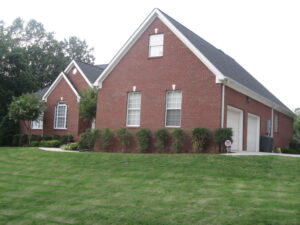 A couple of houses that are in the grass.