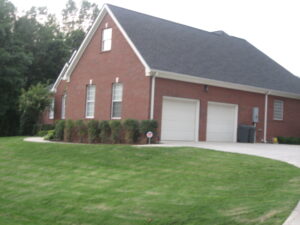 A large brick house with two garage doors.