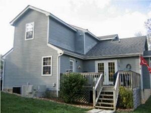 A house with stairs leading to the front door.