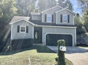 A house with two garage doors and a driveway.