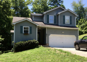 A house with two garage doors and a driveway.