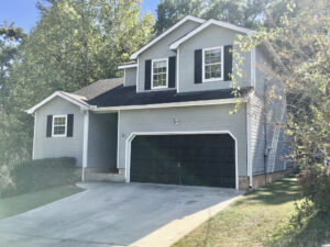 A house with two garage doors and a driveway.