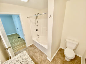 A bathroom with a toilet, tub and shower.