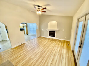 A living room with hard wood floors and a fireplace.