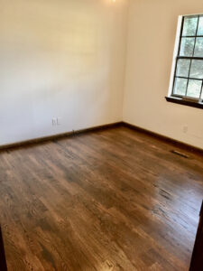 A room with wood floors and white walls.