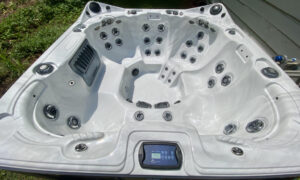 A white hot tub with the top open and showing the controls.