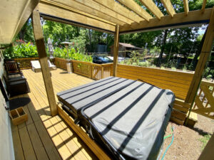 A bed on top of a wooden deck.