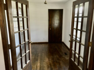 A room with two doors and wooden floors