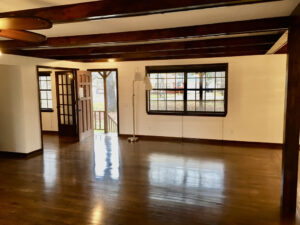 A room with wooden floors and white walls.