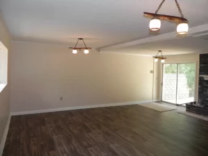 A room with hard wood floors and white walls.