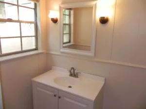 A bathroom with white walls and a sink.