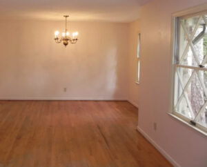 A room with wood floors and white walls.