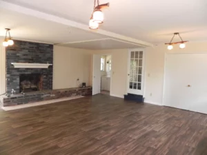 A room with wood floors and white walls.