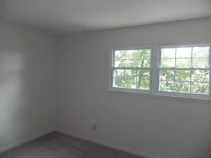 A room with two windows and a door.