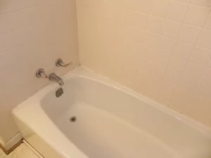 A white bathtub with a faucet in the middle of it.