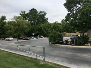 A view of a parking lot with trees and cars.