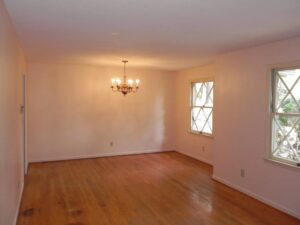 A room with wood floors and white walls.