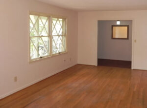 A room with wood floors and white walls.