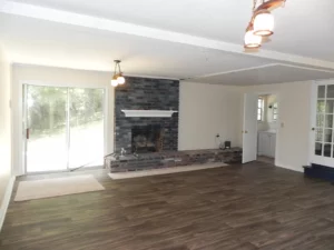 A room with wood floors and a fireplace.