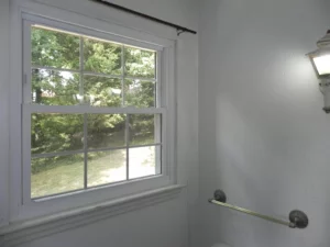 A bathroom with a toilet and window in it