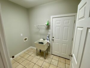 A white door and tile floor in a room.