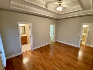 A room with hard wood floors and ceiling.