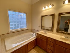 A bathroom with a large tub and sink.