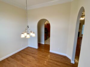 A room with hard wood floors and white walls.