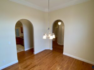 A room with two arched openings and a light fixture.