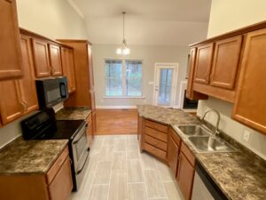 A kitchen with wooden cabinets and granite counter tops.