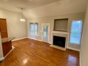 A living room with hard wood floors and fireplace.