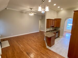 A kitchen with wood floors and a large open floor plan.