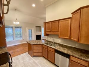 A kitchen with wooden cabinets and granite counter tops.