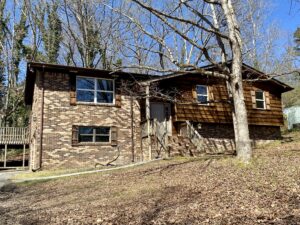 A brick house with trees in the background