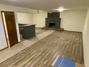 A room with wood floors and a fireplace.