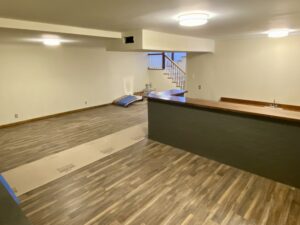 A room with wood floors and a counter.