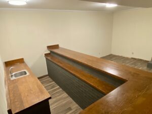 A room with wooden counters and a sink.