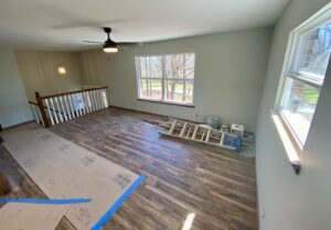 A room with hard wood floors and a ceiling fan.