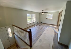 A room with hardwood floors and a wooden railing.