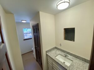 A bathroom with a sink and mirror in it