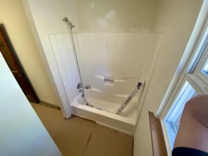 A small bathroom inside a house with white interiors.