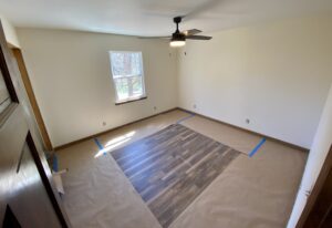 A room with a floor that has been laid out.