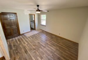 A room with hard wood floors and a door.