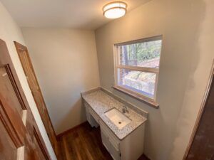 A bathroom with a sink and window in it