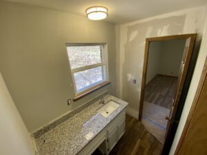 A bathroom with a sink and window in it