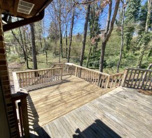 A wooden deck with trees in the background