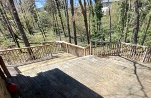 A wooden deck with trees in the background