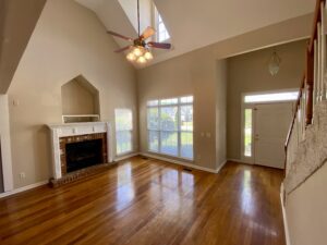 A living room with hard wood floors and fireplace.