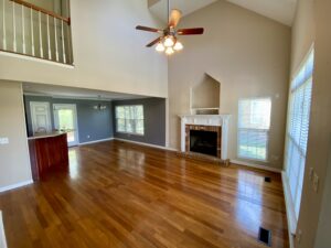 A living room with hard wood floors and fireplace.