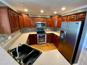 A kitchen with wooden cabinets and stainless steel appliances.